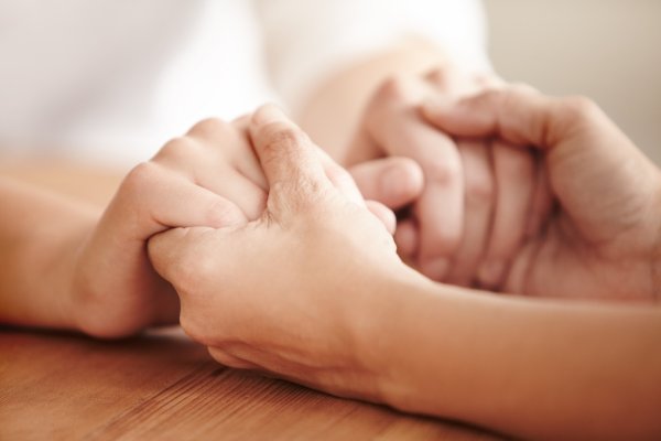 Two individuals holding hands, conveying connection and support
